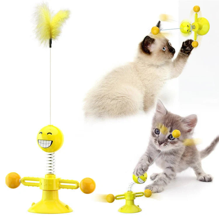 Cat playing with rotating windmill toy featuring suction base and luminous ball