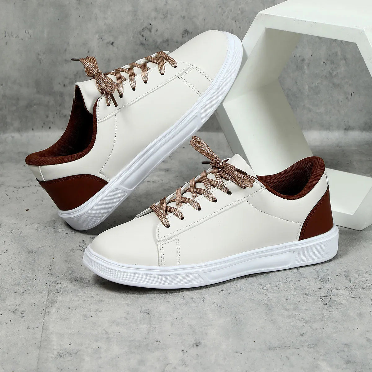 Beige brown women's low-top platform casual sneakers with a cross strap and round toe on a white background.