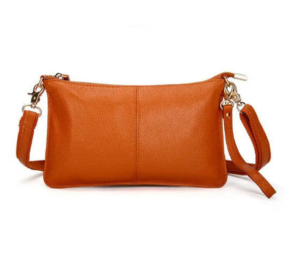 Lady's cowhide slant bag in apricot colour showing front view with strap and compact 24 cm size.