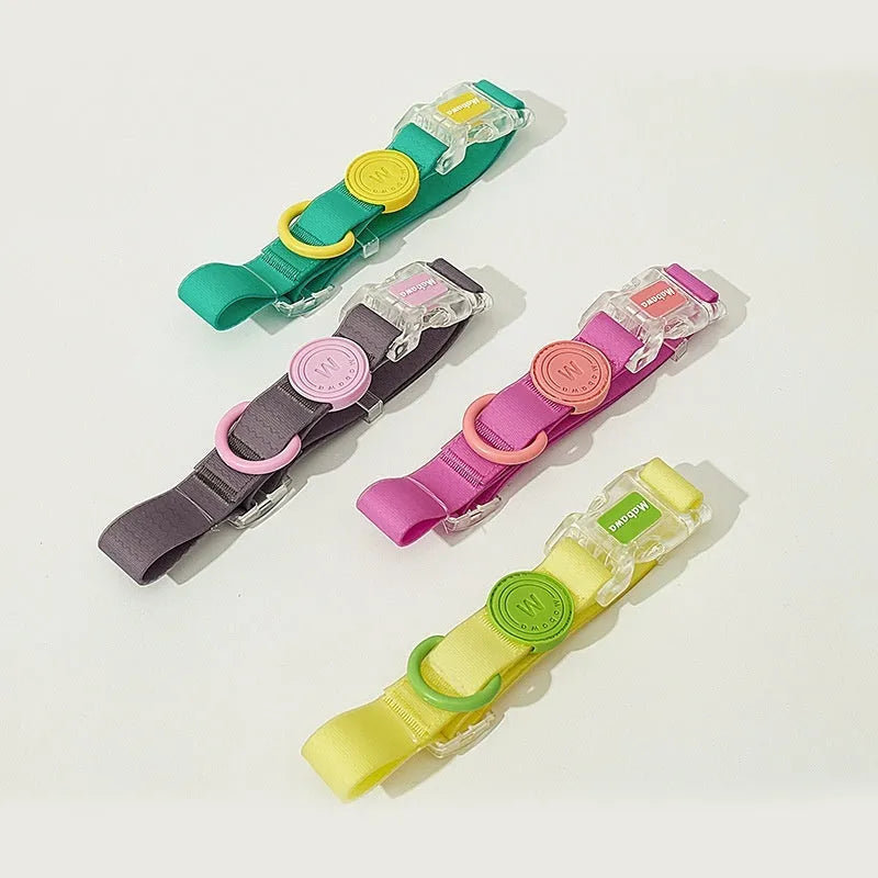 Nylon dog collar and hand holding rope in smoky gray, new green, lemon yellow, and rose pink colour options.