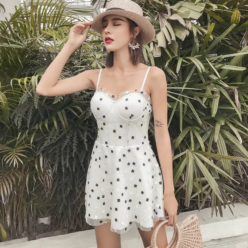 One-piece swimwear in white and black, made from 100% polypropylene for water resistance