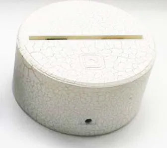Modern white lotus-shaped LED night light with touch control on a wooden surface.