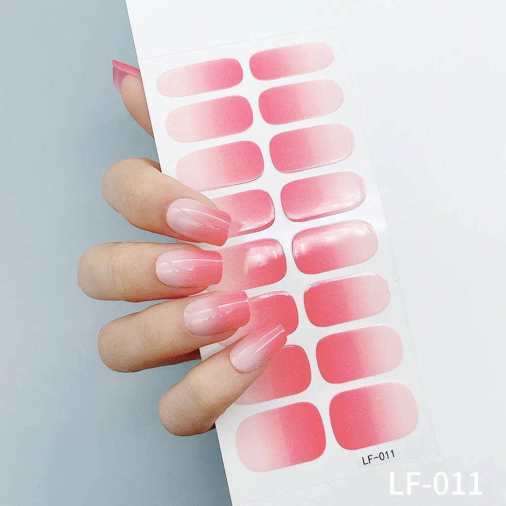 Sheet of 16 small design nail art stickers including cross, rose, tulip and marble patterns.