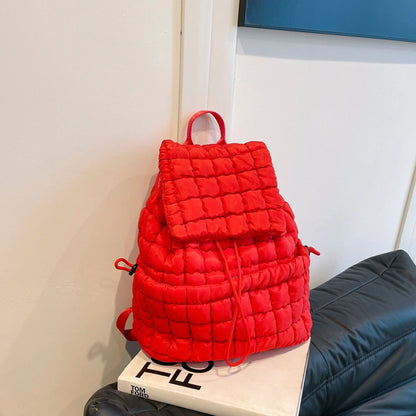 Soft, quilted puffer backpack in a variety of colors, perfect for autumn and winter wear