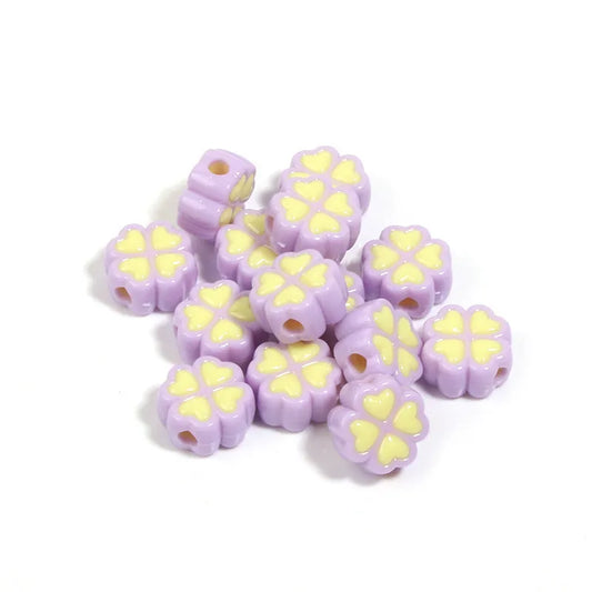 Assorted frosted acrylic four-leaf clover shaped beads in pink, green, and yellow, 15mm diameter.