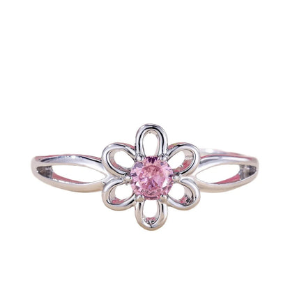Women's hollow flower design fashion ring in electroplated copper with a platinum pink diamond finish.