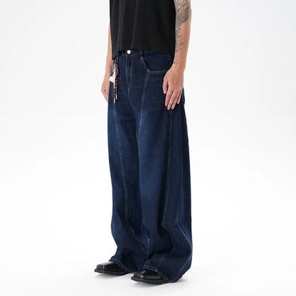 Woman wearing dark blue distressed wide leg denim jeans in a casual setting.