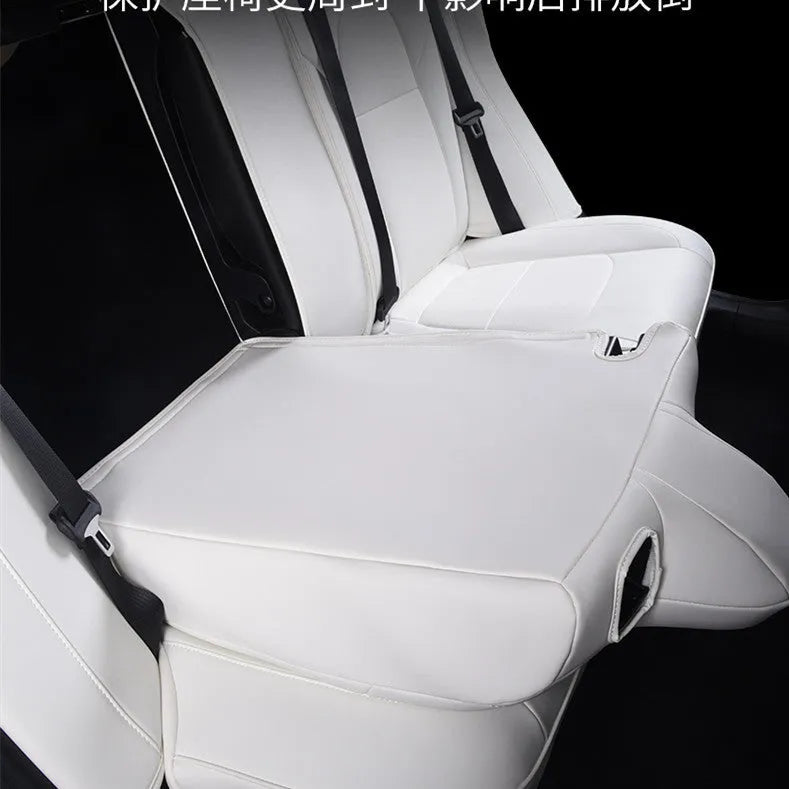 Black PVC seat cover installed on a Tesla Model 3 front seat, showing binding-style edges.