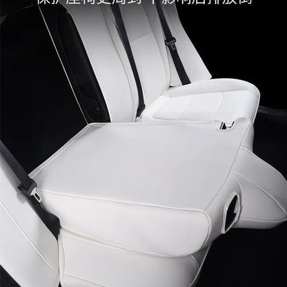 Black PVC seat cover installed on a Tesla Model 3 front seat, showing binding-style edges.