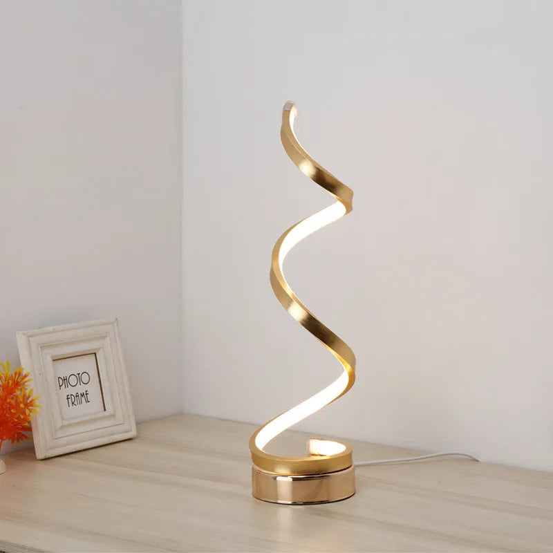 Black and white minimalist LED bedside lamp with aluminium shade and tri-colour dimming on a table