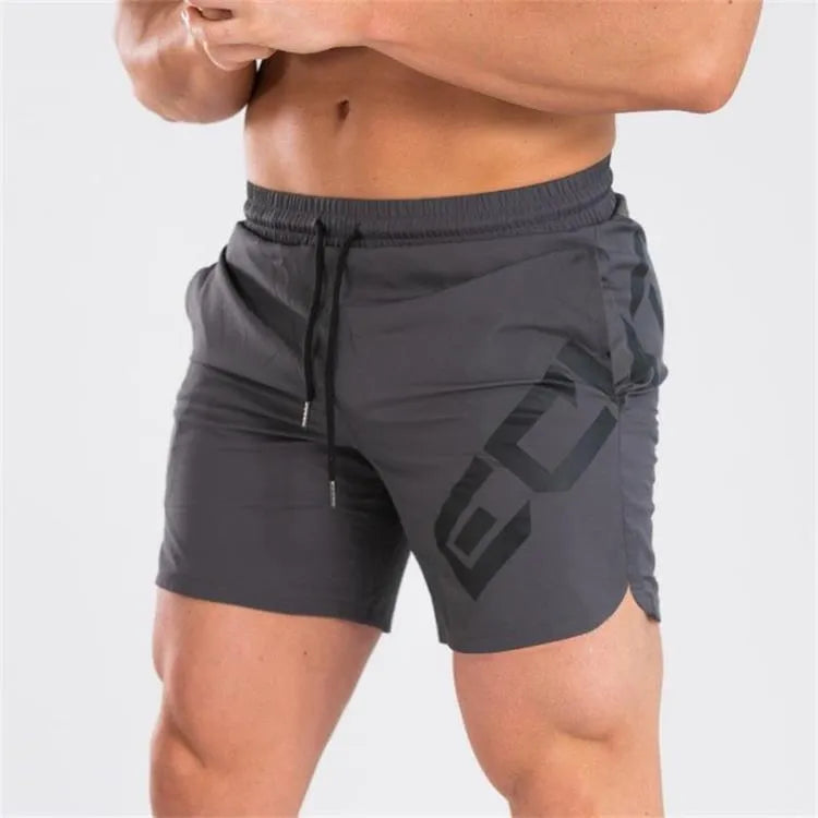Men's black quick-dry training shorts with elastic waistband, shown knee-length.