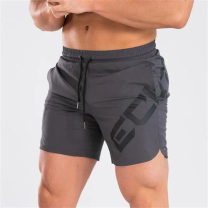 Men's black quick-dry training shorts with elastic waistband, shown knee-length.