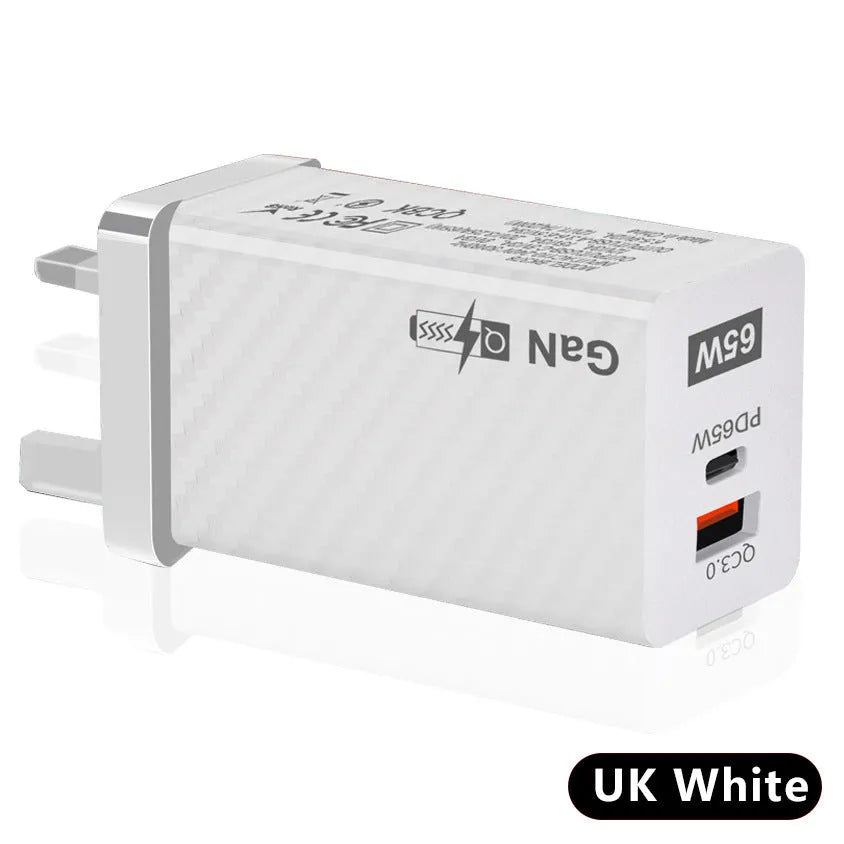 White or black GaN 65W universal laptop charger with USB-C port and compact design next to EU and US plugs