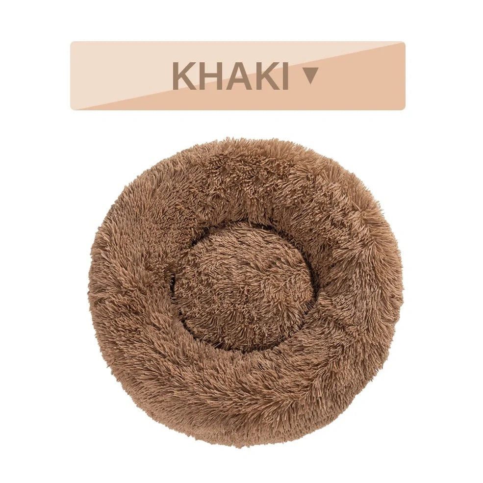 Fluffy donut-shaped dog bed in dark grey colour with raised edges, showing plush texture and circular design