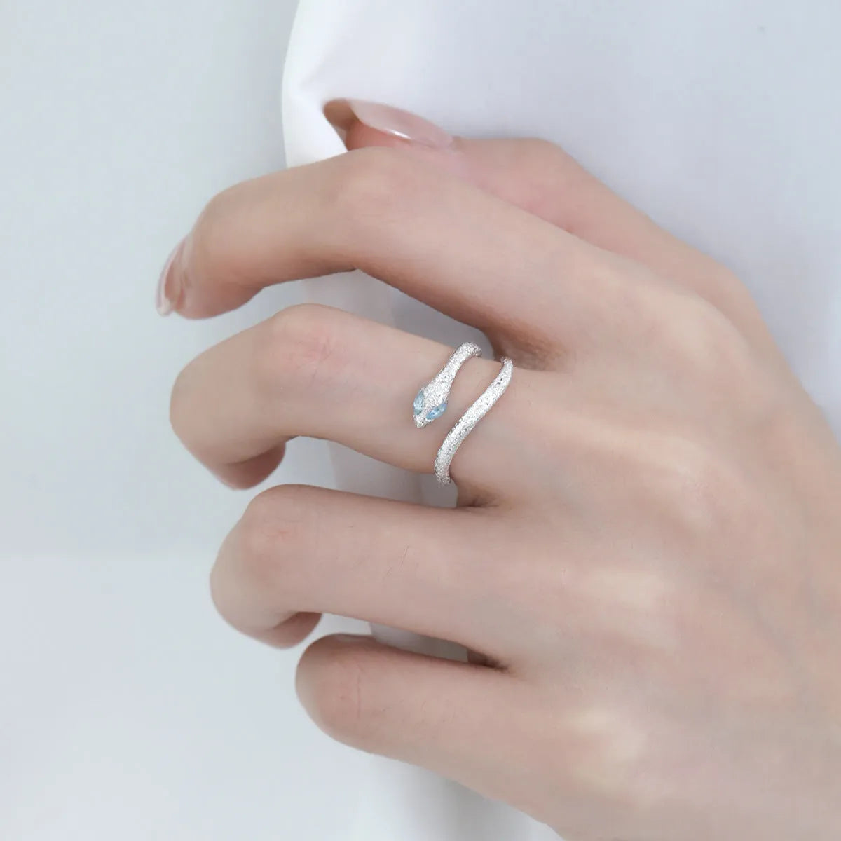 Cool Style Minority adjustable silver snake ring with platinum-colour finish on a hand, showing detailed modelling and open band.