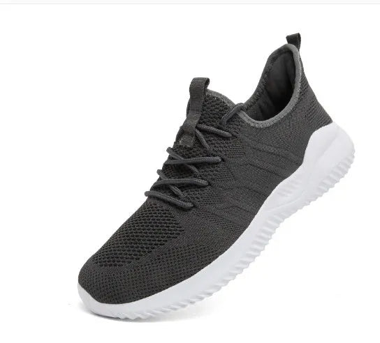 Men's black and white mesh sneakers with a lace-up front and round toe, shown on a plain background.