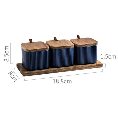 Elegant ceramic seasoning jars with wooden accents, providing stylish and organized storage for kitchen spices and herbs