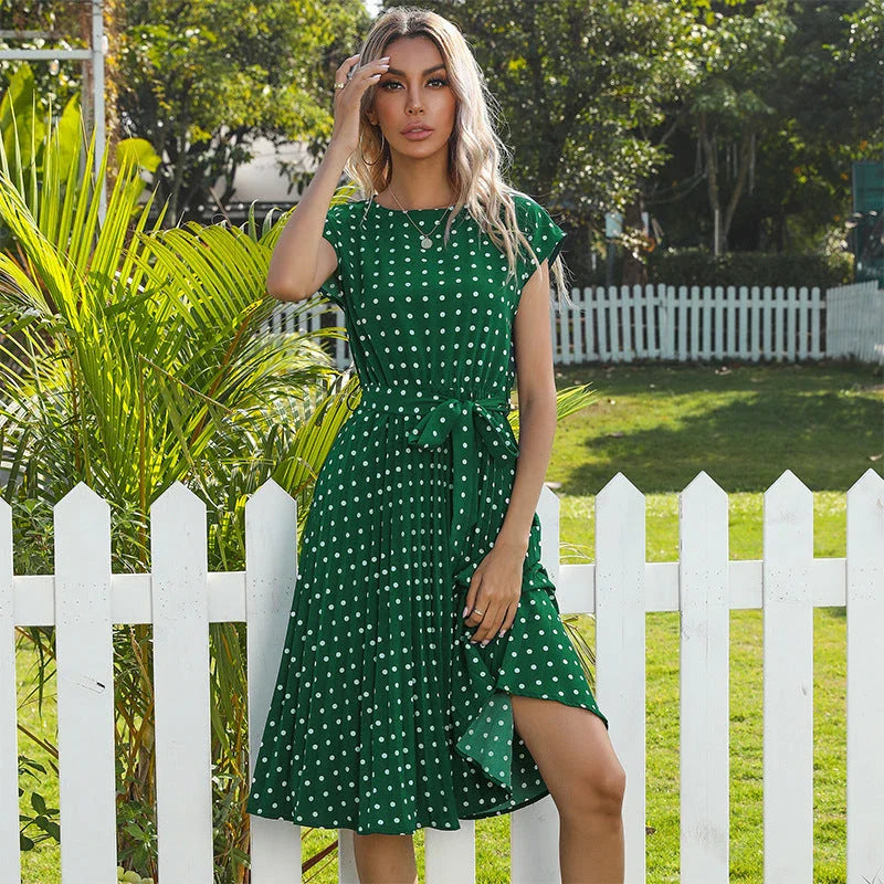 Elegant polka dot midi dress with short sleeves, made of soft viscose fabric and featuring a flattering pleated A-line skirt
