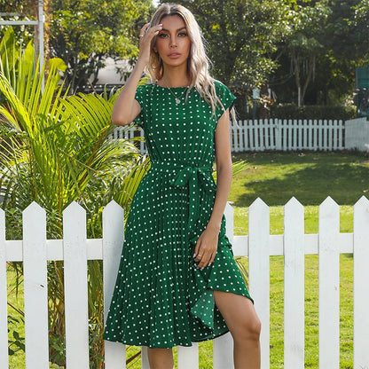 Elegant polka dot midi dress with short sleeves, made of soft viscose fabric and featuring a flattering pleated A-line skirt