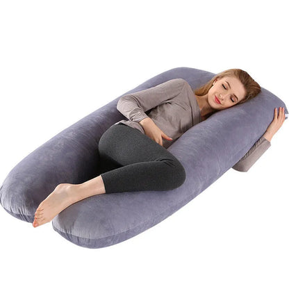 Large U-shaped pregnancy support pillow with removable cover and abdominal support belt.