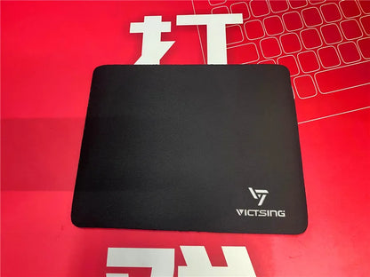 Large black thickened rubber mouse pad with a rough grain texture on a desk.