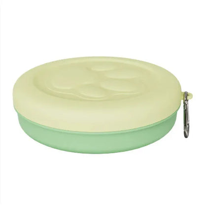 Collapsible silicone dog bowl with integrated snack compartment in light pink colour