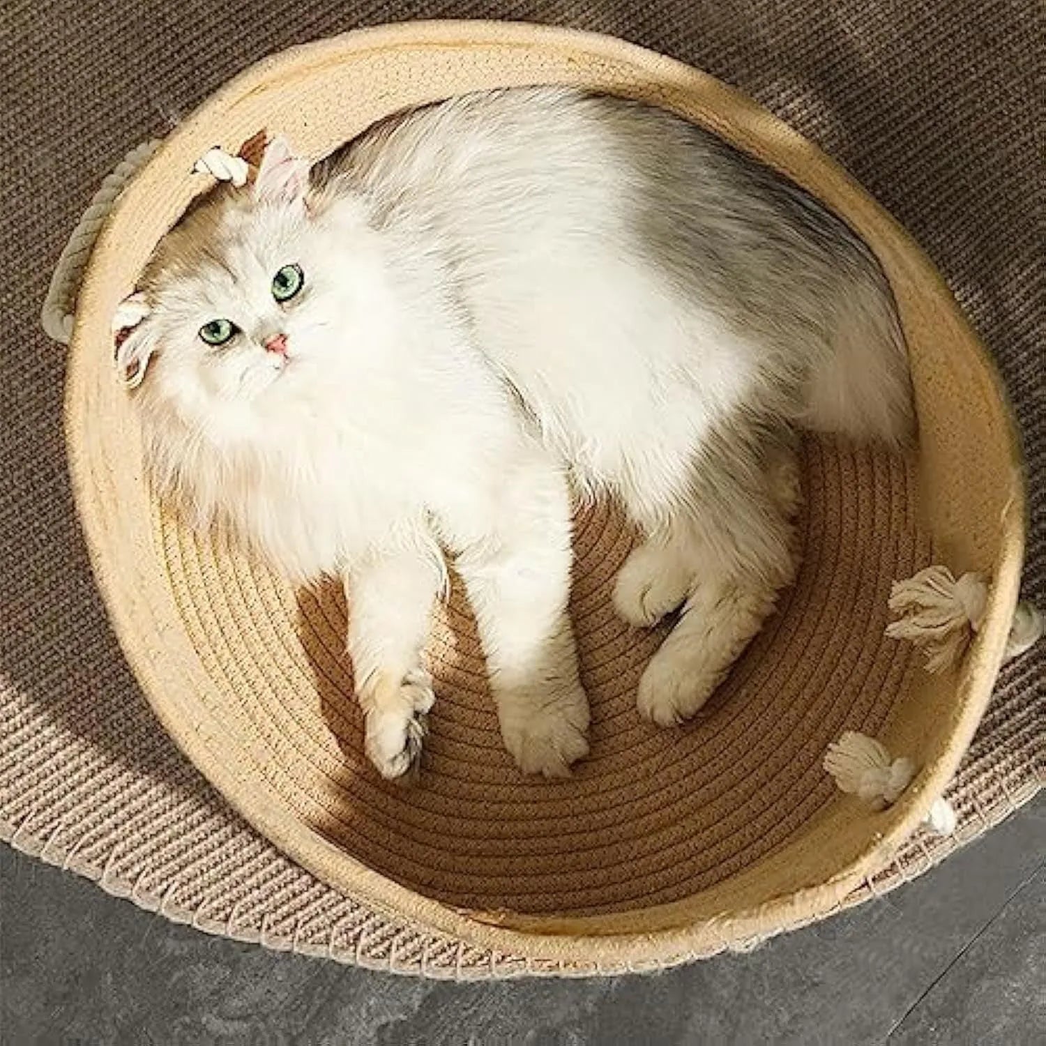 Natural wicker cat basket with integrated corrugated cardboard scratching panel side.