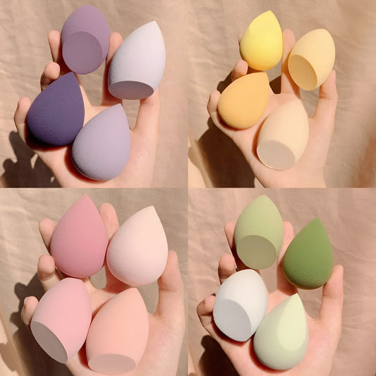 Four synthetic sponge makeup eggs in grape, mango, mint, and peach peach colours