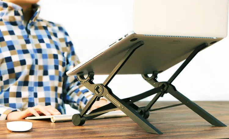 Black folding portable laptop stand with aluminium frame, shown open supporting a laptop and folded to 4cm thickness.
