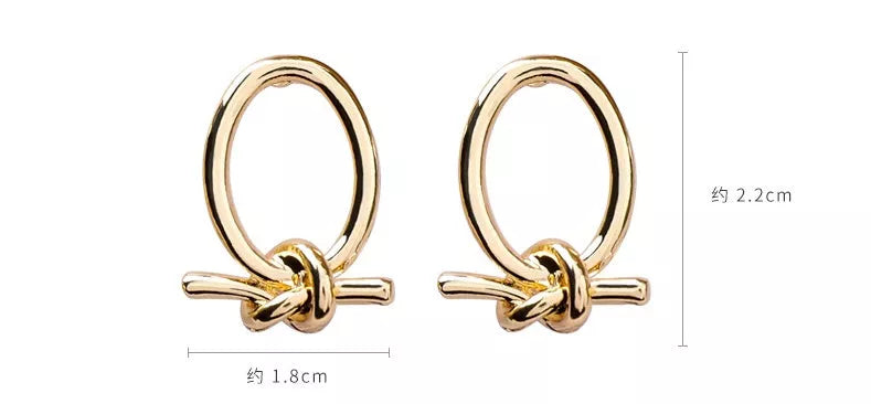 Gold alloy stud earrings with oval knotted design
