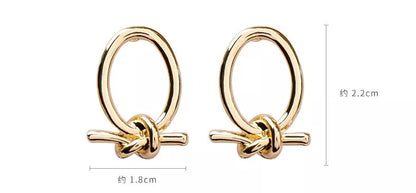 Gold alloy stud earrings with oval knotted design