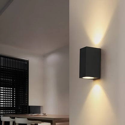 Black LED wall lamp with aluminium body and glass shade mounted on wall