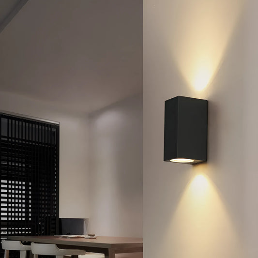 Black LED wall lamp with aluminium body and glass shade mounted on wall
