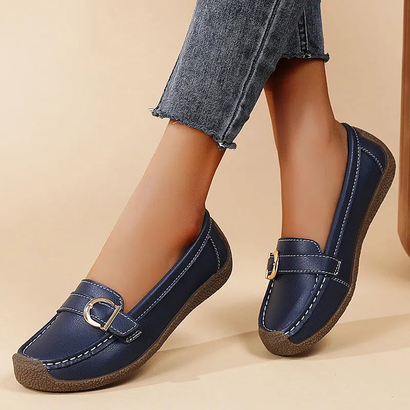 Women's beige casual loafers with round toe and flat heel on a white background.