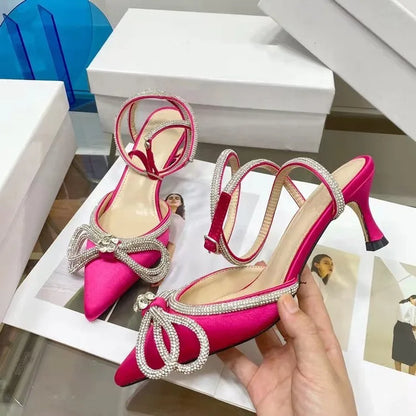Women's black French style stiletto heel sandals with a silk back bandage and silver buckle closure.