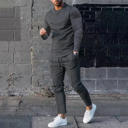 Men's light grey polyester two-piece suit set with long sleeve round neck T-shirt and matching trousers.