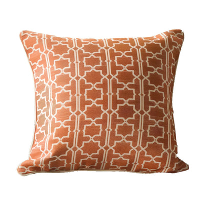 Square beige cushion cover with envelope closure on a grey sofa