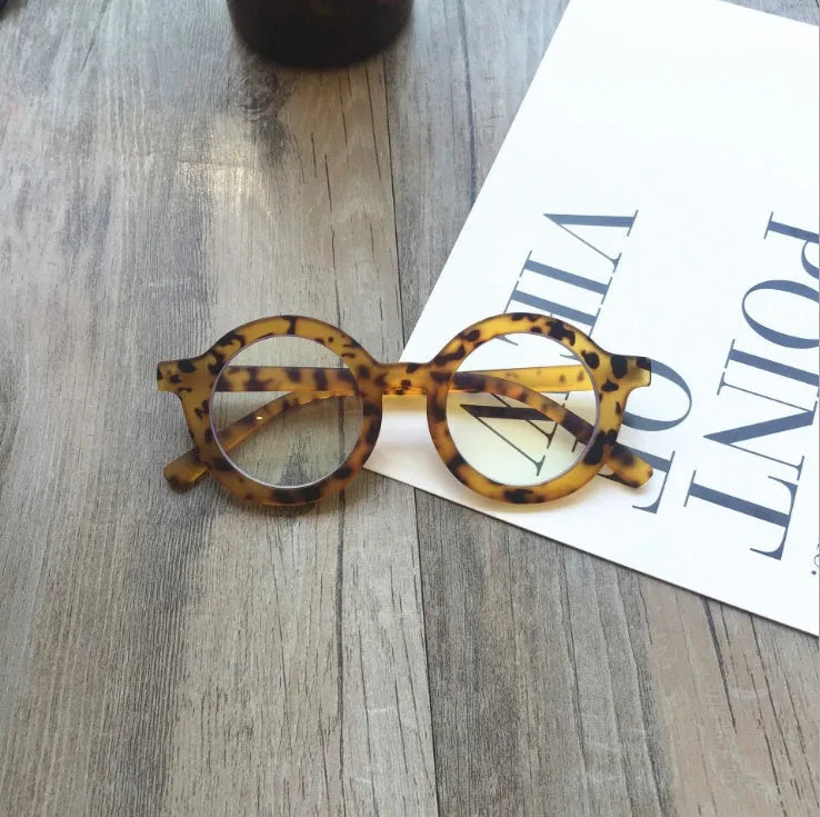 Retro round frame anti blue light glasses in various colours on a plain background