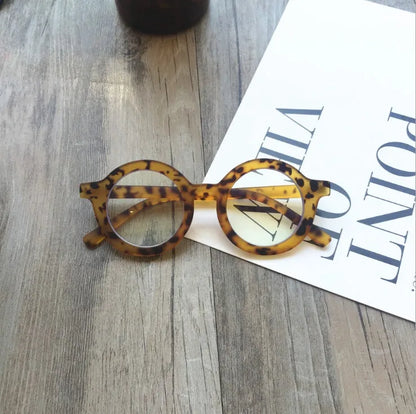 Retro round frame anti blue light glasses in various colours on a plain background