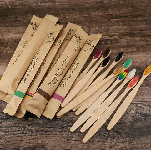 10 bamboo toothbrushes with charcoal bristles in multiple colours including green, purple, yellow, white, grey and black