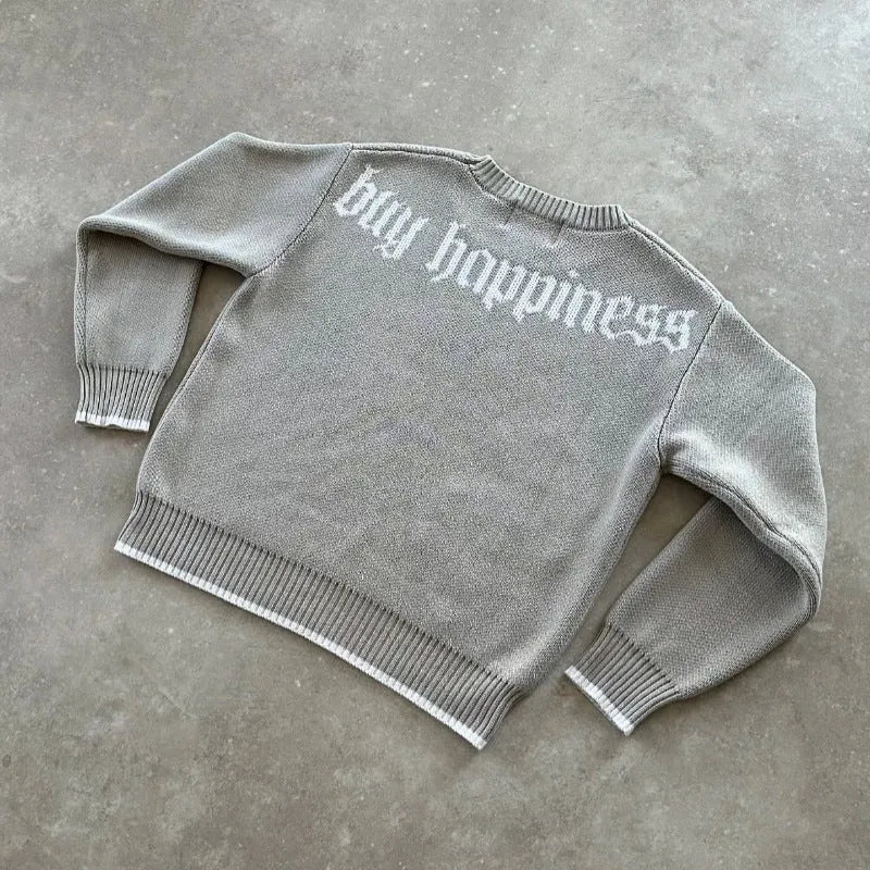 Grey loose-fitting jacquard knit coat with long sleeves on a hanger
