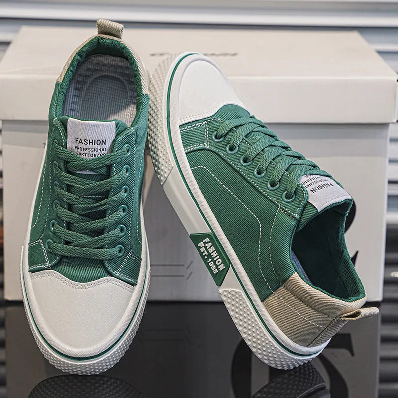 Men's low-top blue canvas skate shoes with round toe and flat heel on a white background.