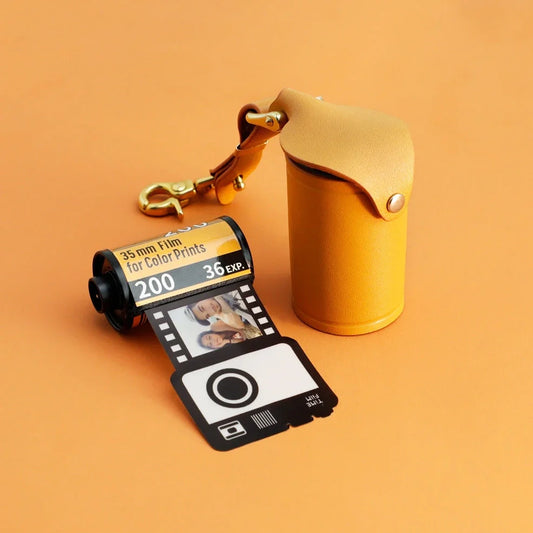 Yellow plastic film roll keychain with custom photo insertion compartment measuring 7cm