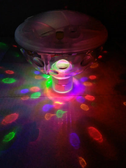 Children's floating LED bath lamp showing 8cm cube design with multiple colour lighting effects in water