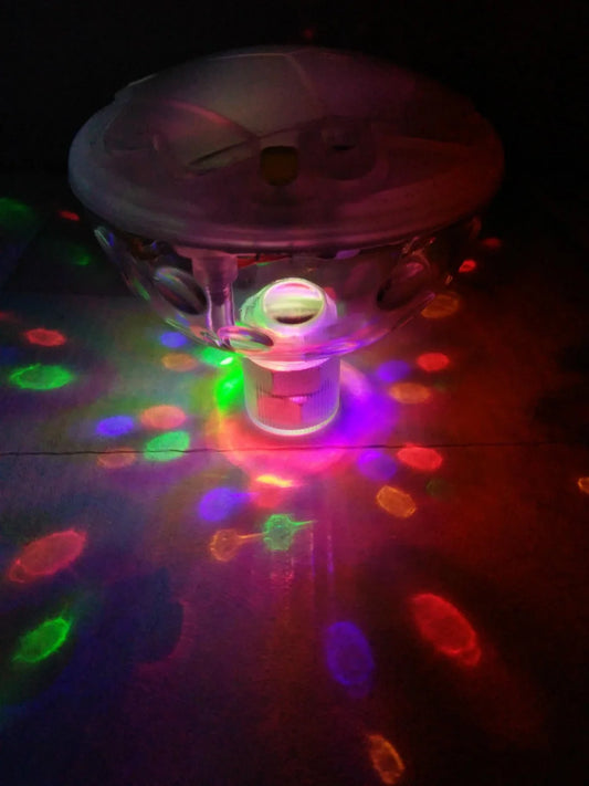 Children's floating LED bath lamp showing 8cm cube design with multiple colour lighting effects in water