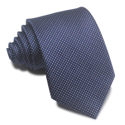 Close-up of a red and black striped jacquard weave tie with an arrow tip, showing texture.