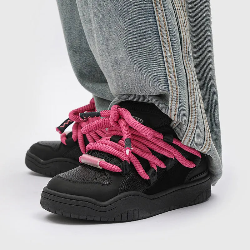 A pair of thick-soled casual lace-up shoes in a solid colour with a round toe and mesh lining.