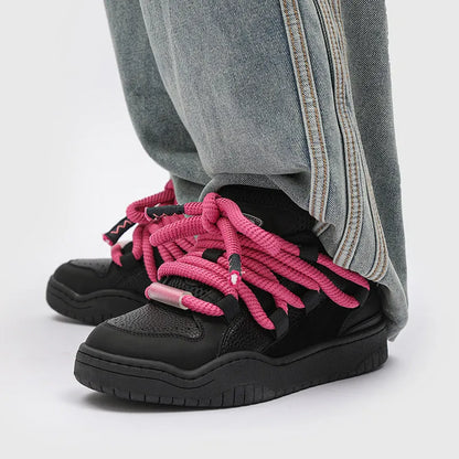 A pair of thick-soled casual lace-up shoes in a solid colour with a round toe and mesh lining.