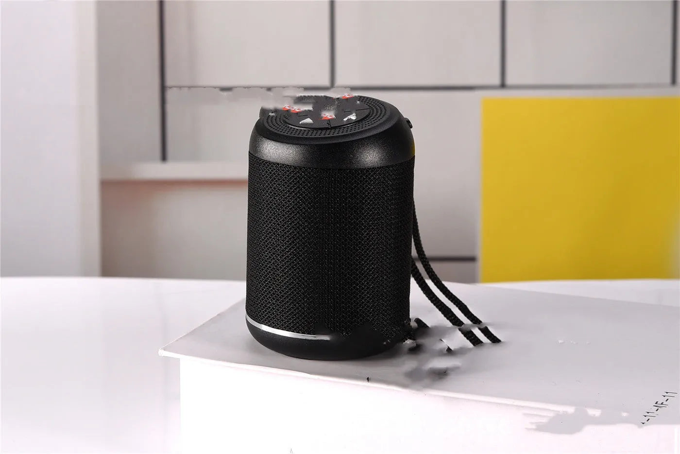 Portable outdoor Bluetooth subwoofer speaker in multiple colours showing button controls.