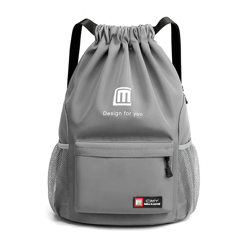 Large bucket-shaped travel backpack in blue with drawstring closure and soft black shoulder straps.